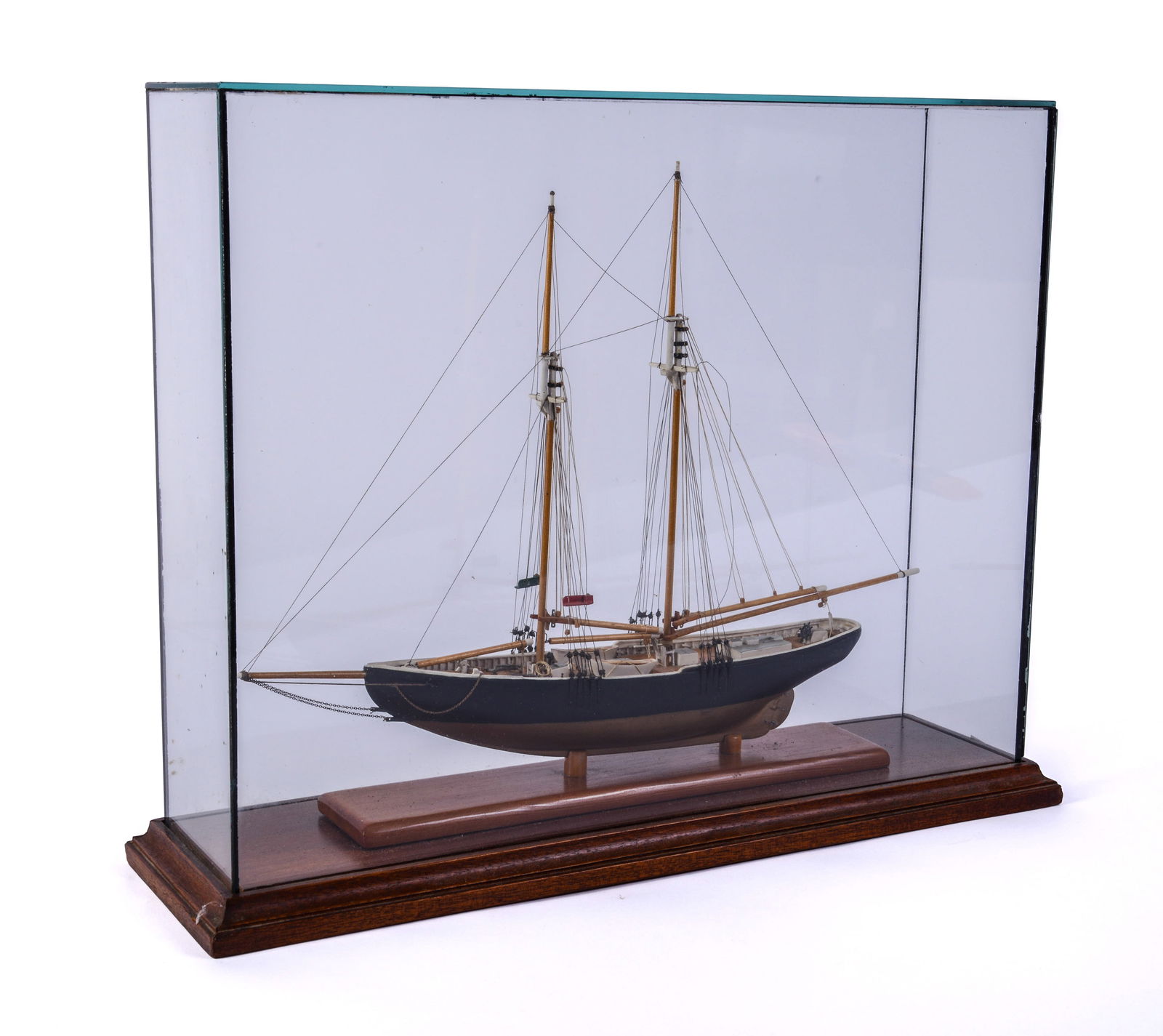 Small Cased Model of a Two Masted Schooner.: Case 13.5 x 17 x 5 inches. Some rigging repair needed, overall good condition.