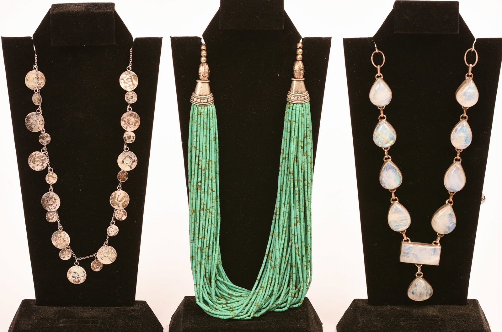 Three Necklaces.: One sterling with discs, length 15 inches, as well as one turquoise and one moonstone. Stands included.