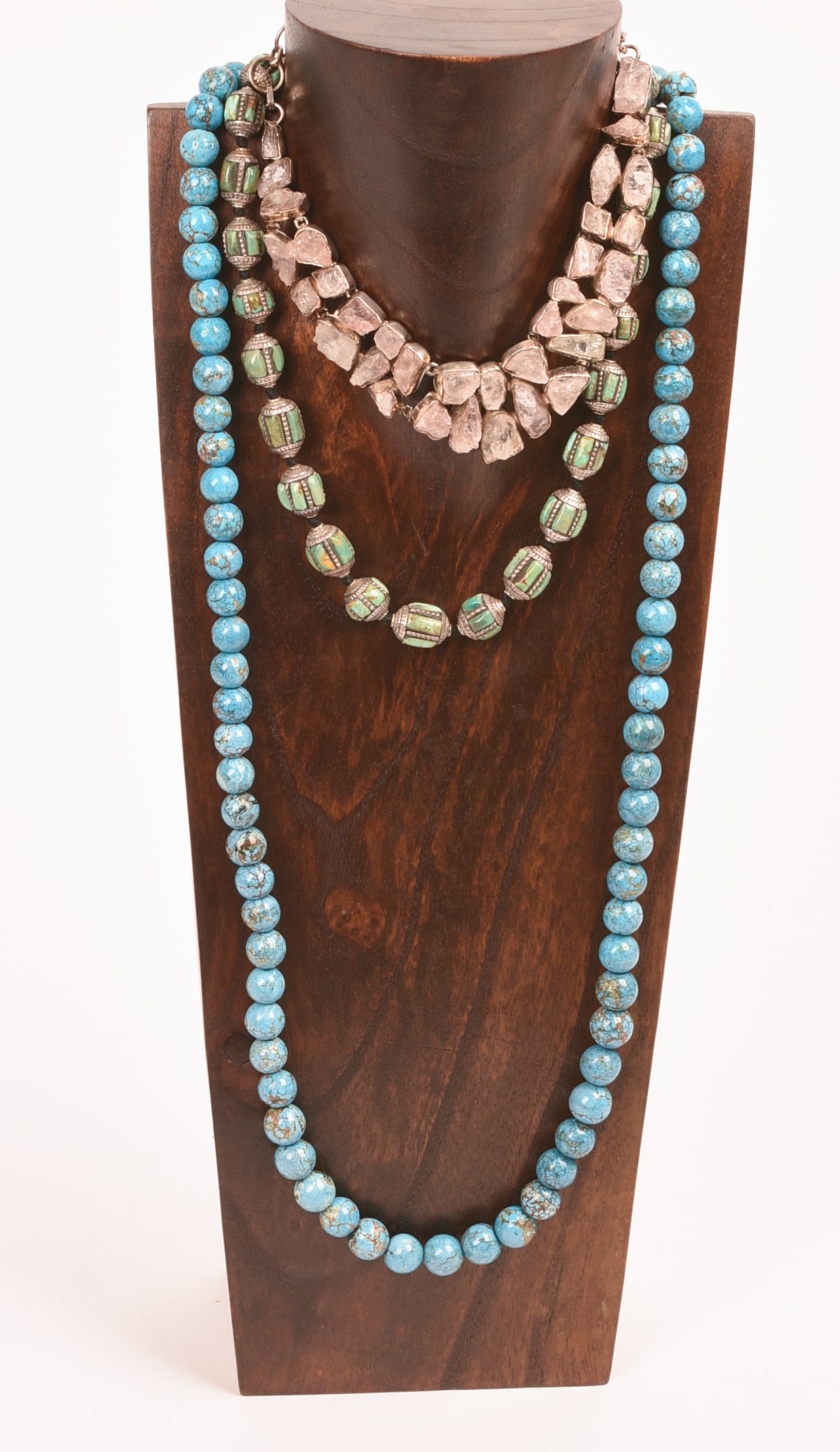 Three Necklaces.: Two Turquoise, one rose quartz. Longest 30 inches. Stand included.