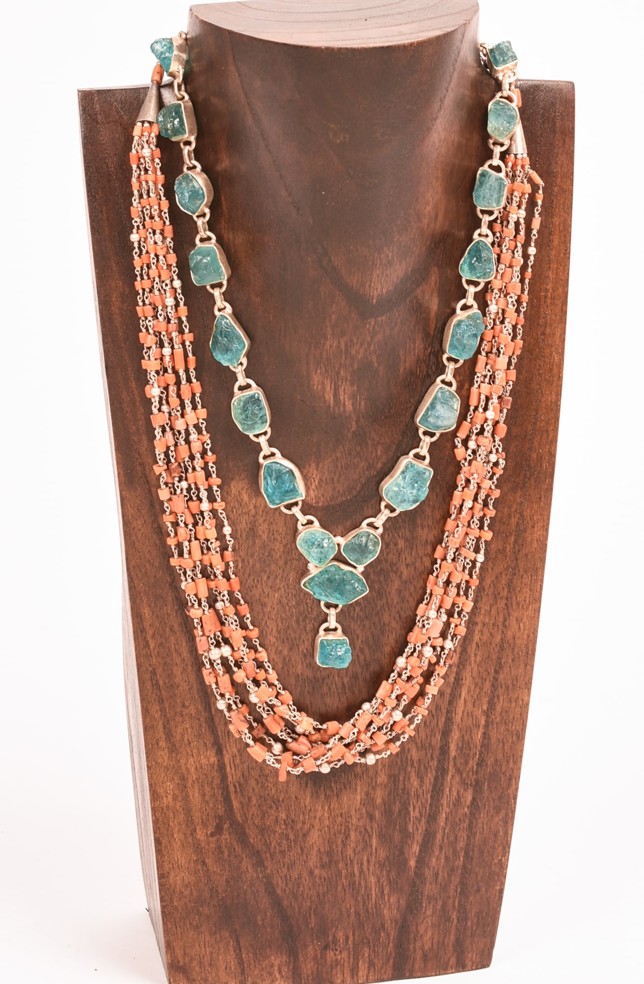 Two Necklaces: Quartz and Coral.: Length of coral necklace 17 inches. Stand included.