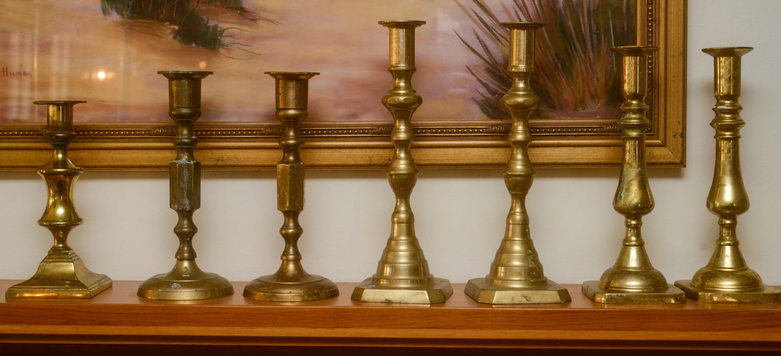 Seven Brass Candlesticks.: Heights 7 to 9 inches.