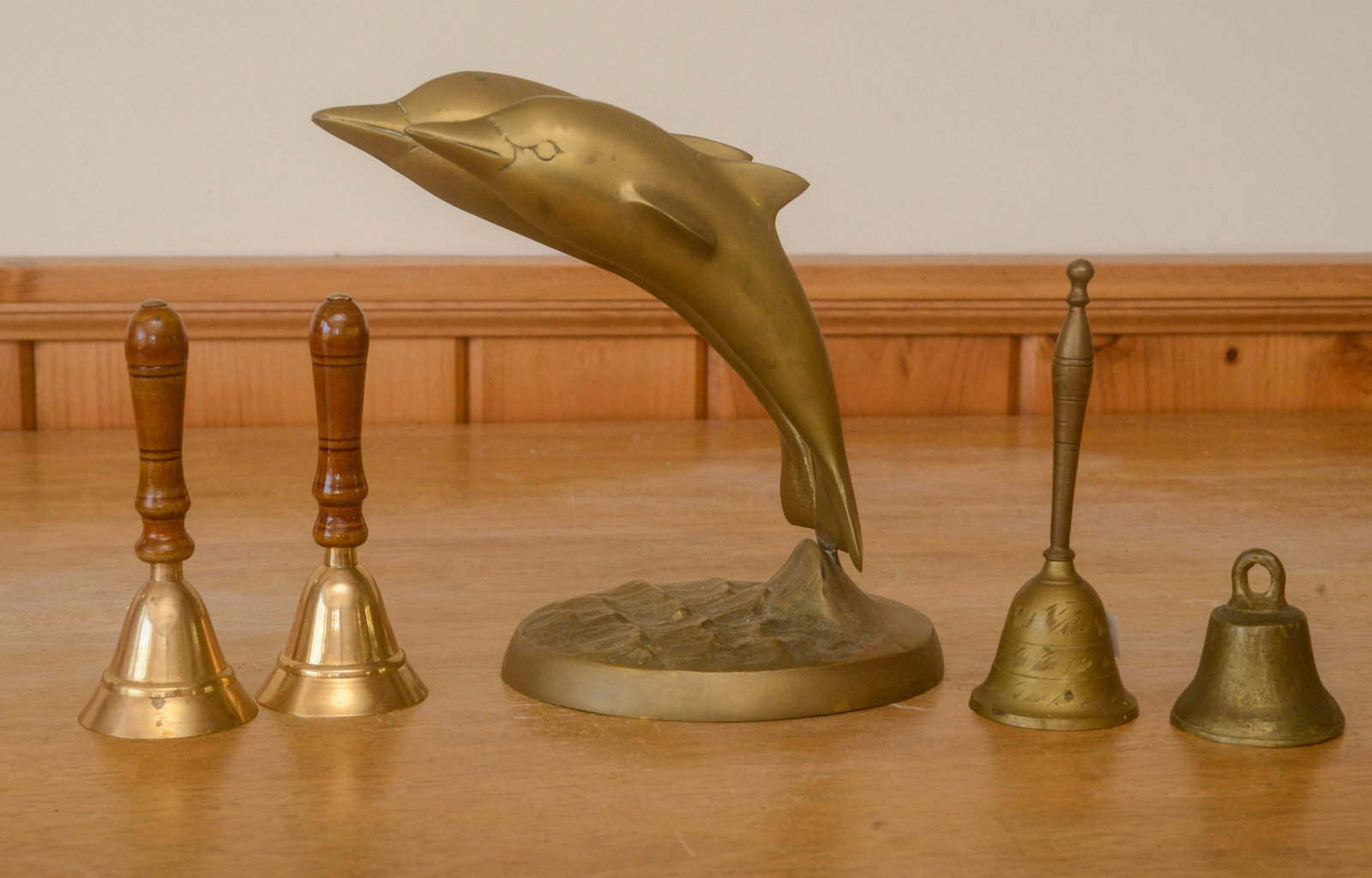 Brass Dolphin Sculpture and Four Bells. (1 of 3)