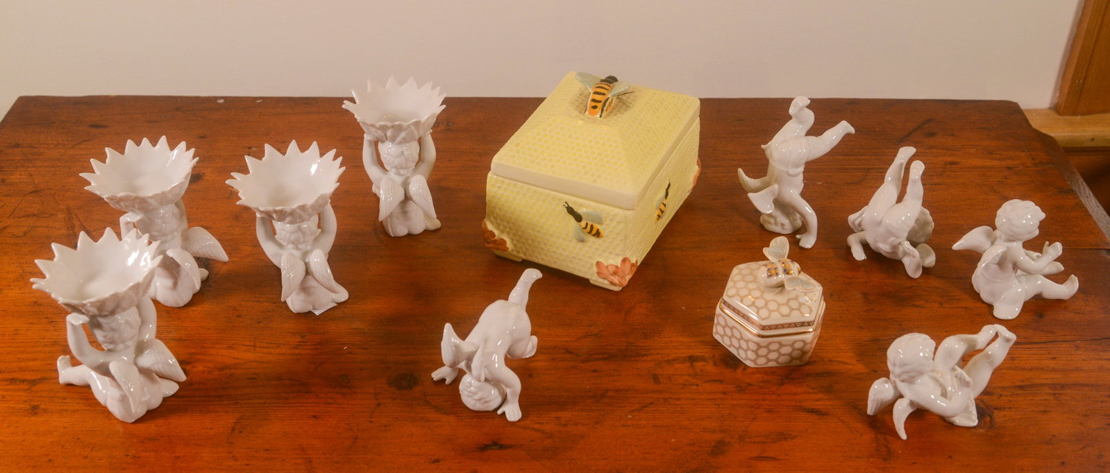 Group of Porcelain Cherub Figures.: Heights 3 inches. Together with 2 boxes.