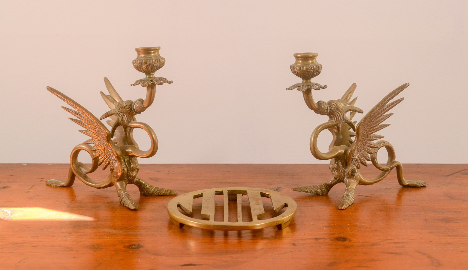 Pair of Brass Dragon Candlesticks and a Trivet: Height of candlesticks 7.25 inches.