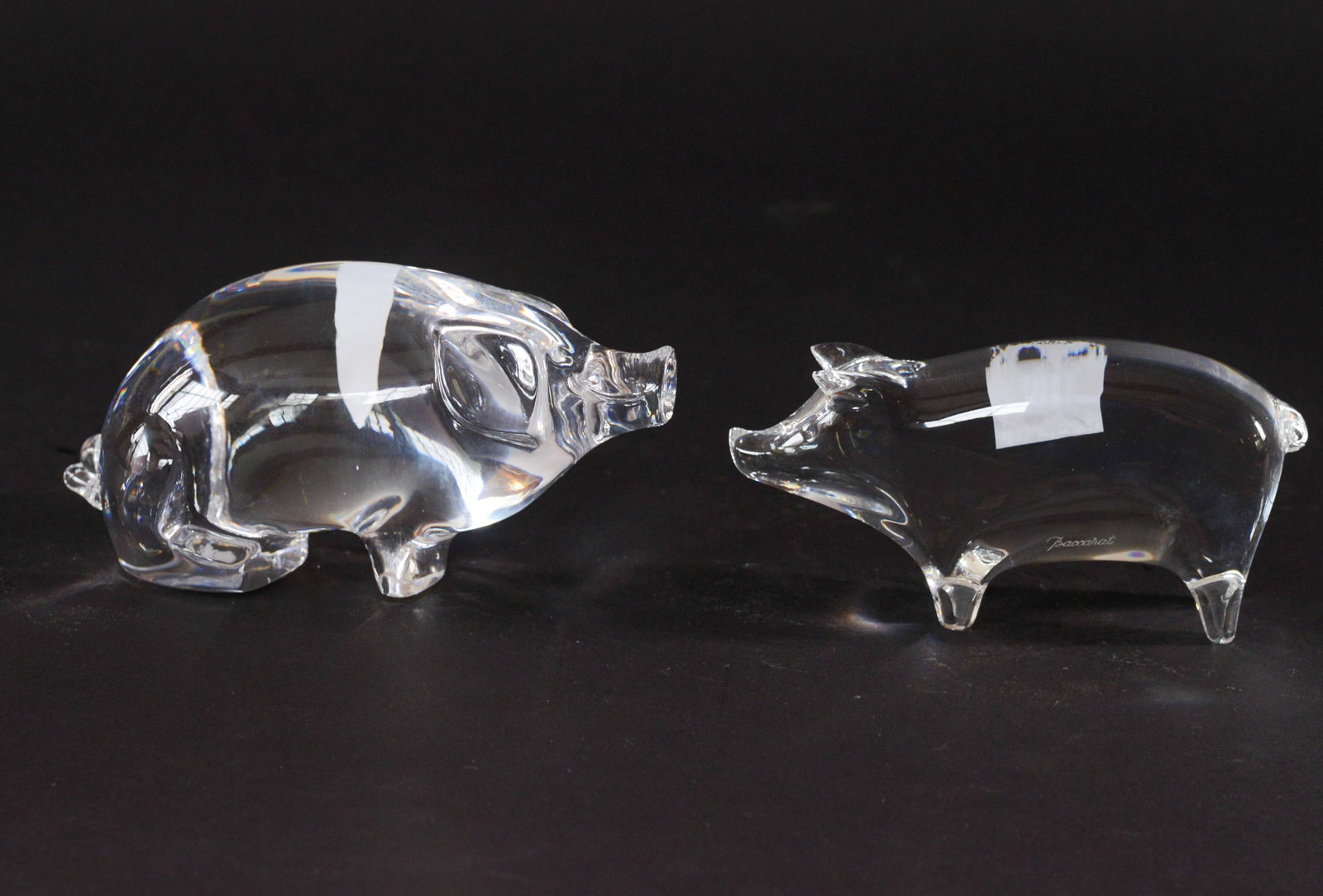 Two Crystal Pigs.: One Baccarat, length 5.5 inches, the other Orrefors.