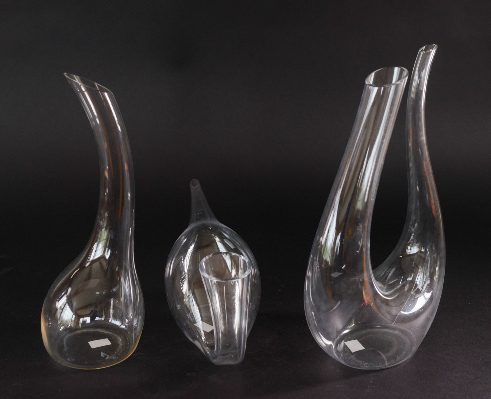 Three Decanters.: One marked Riedel, length 14 inches.