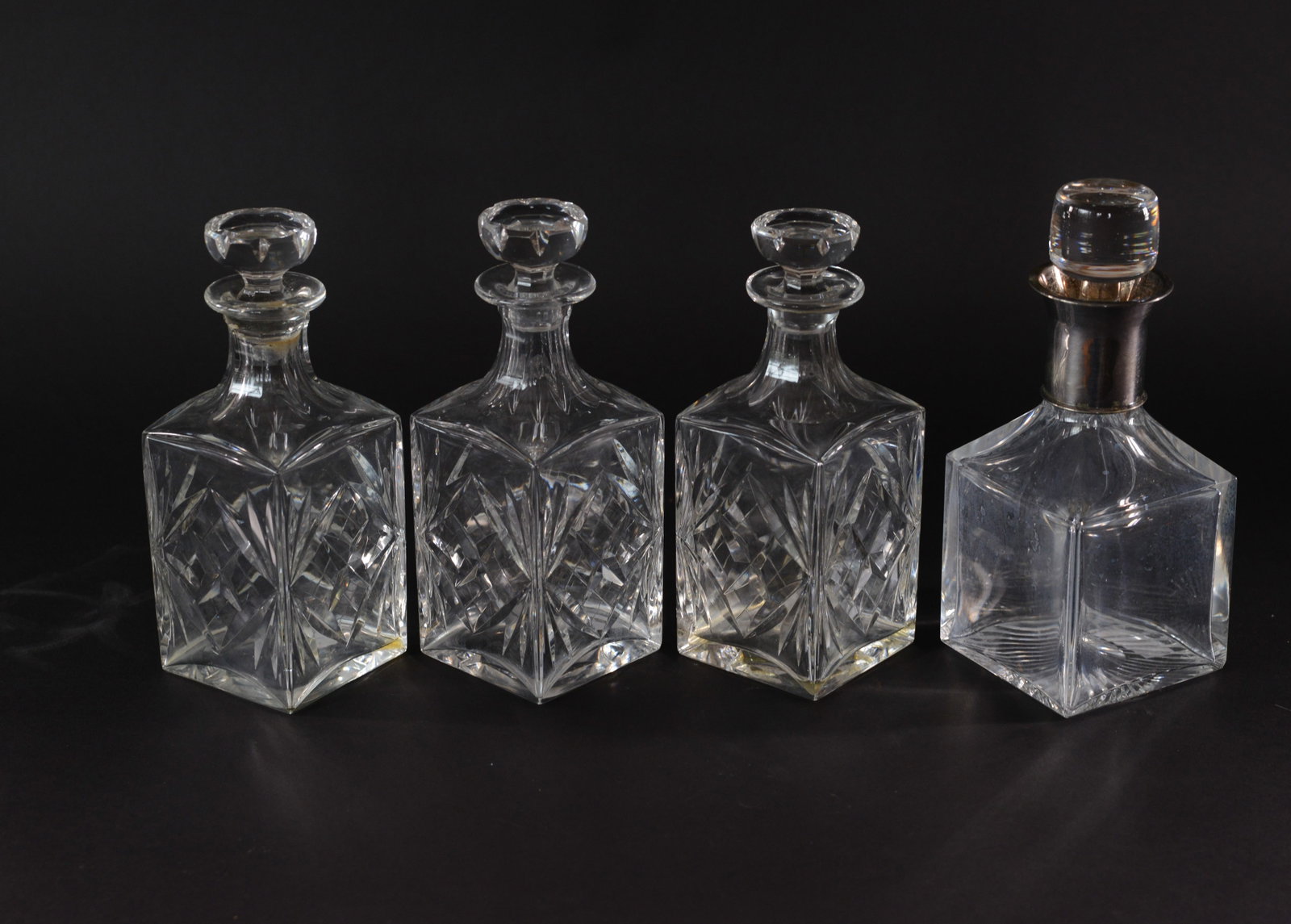 Four Crystal Decanters.: Heights 9 to 9.75 inches.