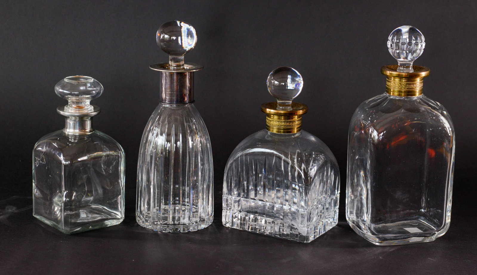Four Crystal Decanters.: Heights 8 to 11 inches.