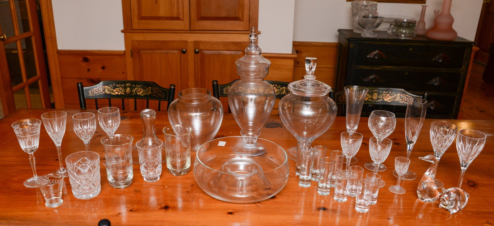 Assorted Glass and Crystal: Steuben duck, stem glasses, champagne flutes, covered jars, and others.