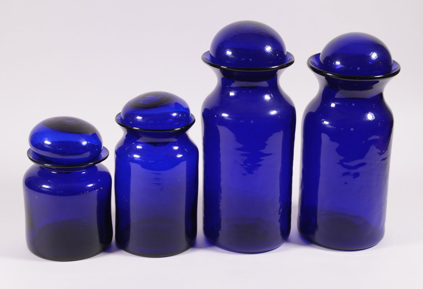 Four Cobalt Blue Apothecary Jars.: Heights 8 to 14 inches.