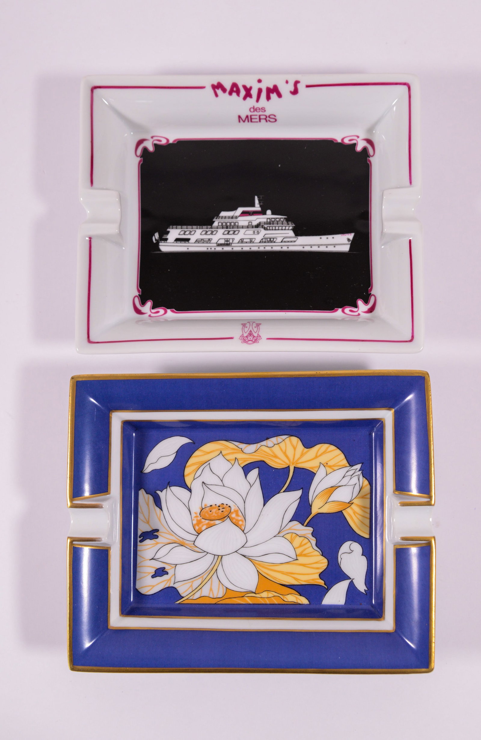 Two Ashtrays: Hermes and Limoges.: Limoges, Maxim's des Mers, and a floral design by Hermes. Each 7.5 x 6 inches.