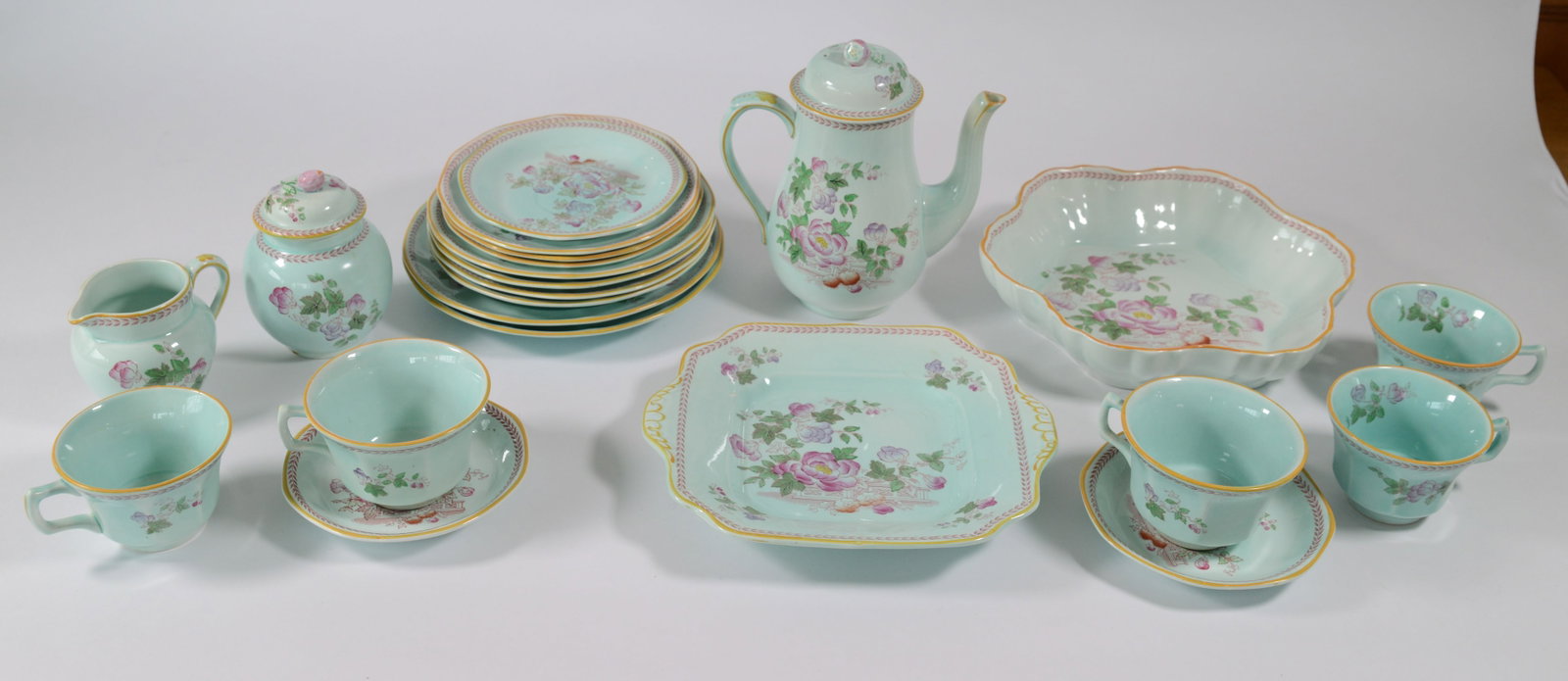 Adams Calyx Ware Part Tea Service.: Coffeepot, creamer and sugar, five teacups, and others. Hairline crack to coffeepot.