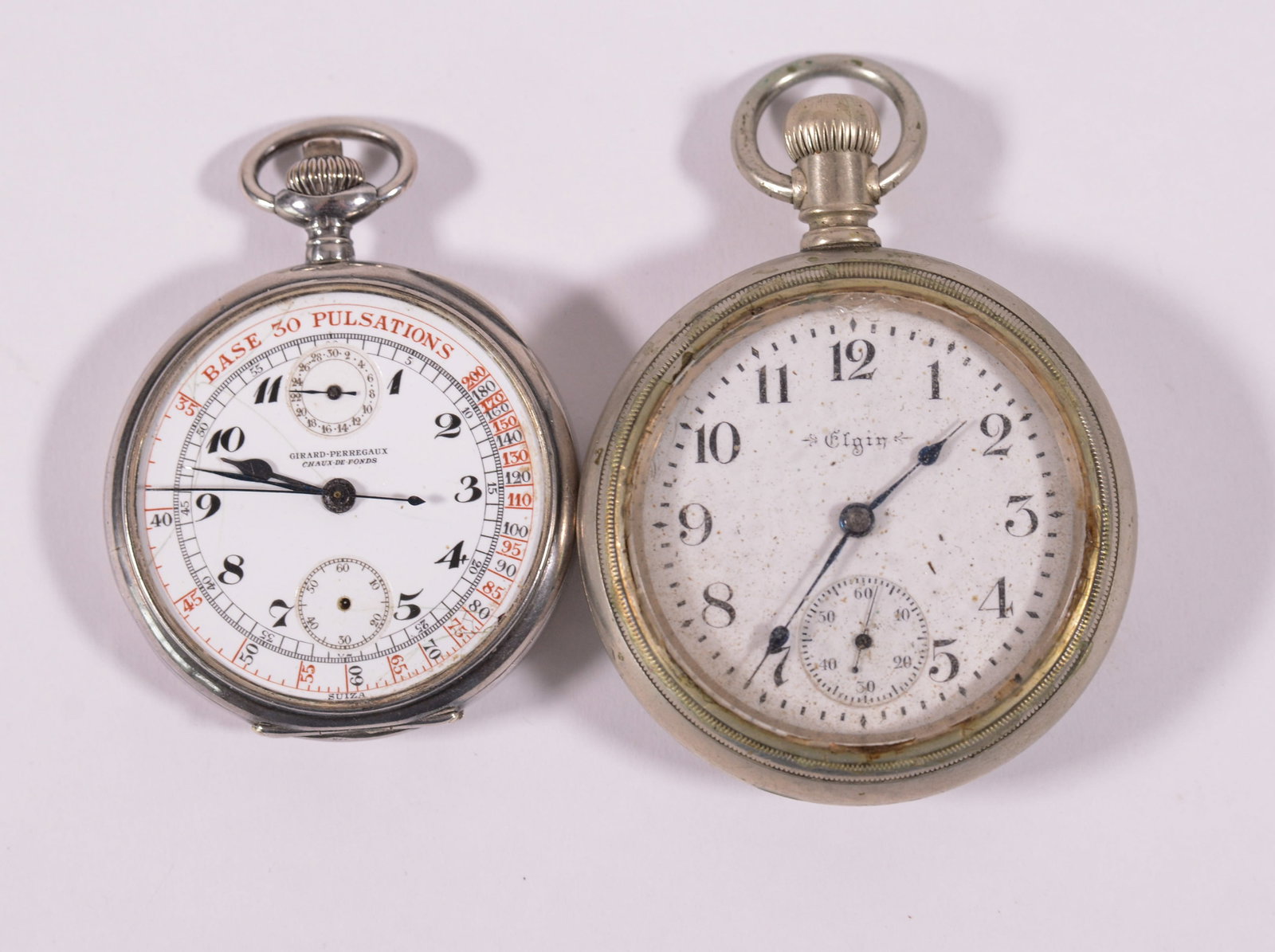 Two Pocket Watches.: Elgin, diameter 2.25 inches, and Girard-Perregaux (lacking glass). Elgin appears to be operational.