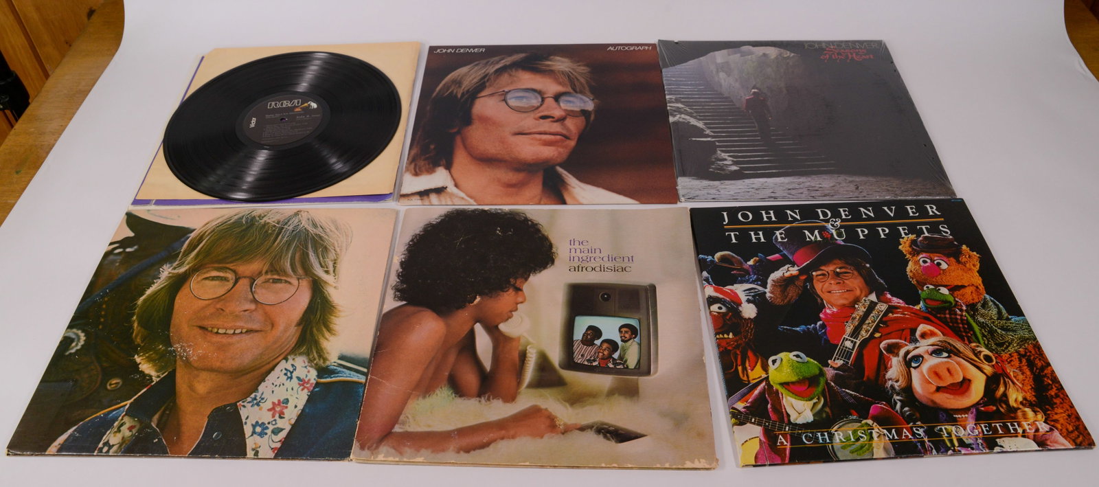 Five John Denver Records.: Several in original shrink wrap. Jerry Weintraub signed John Denver in 1970, and was the driving force behind his commercial success.