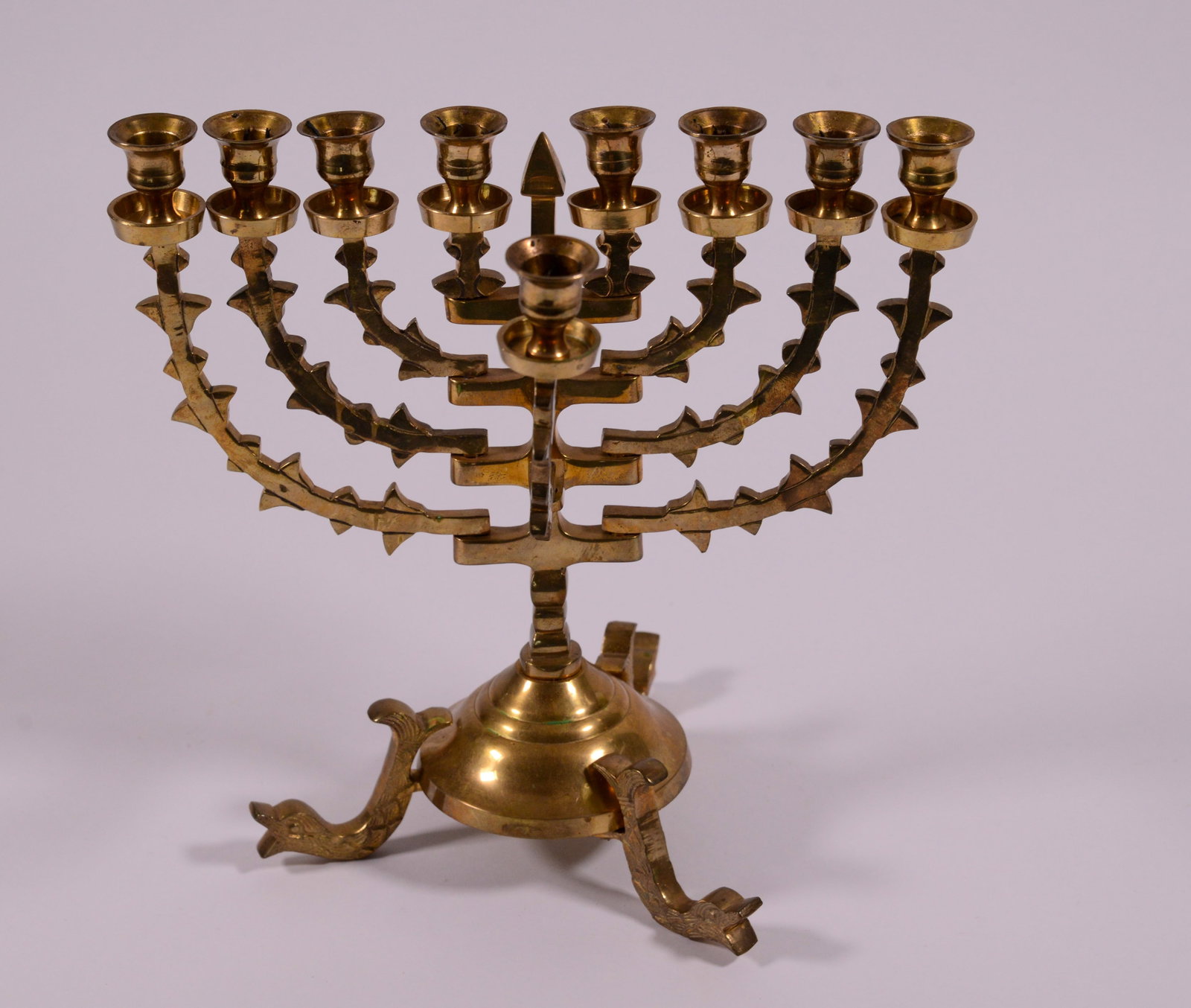 Brass Menorah With Dolphin Feet.: Height 10 inches.