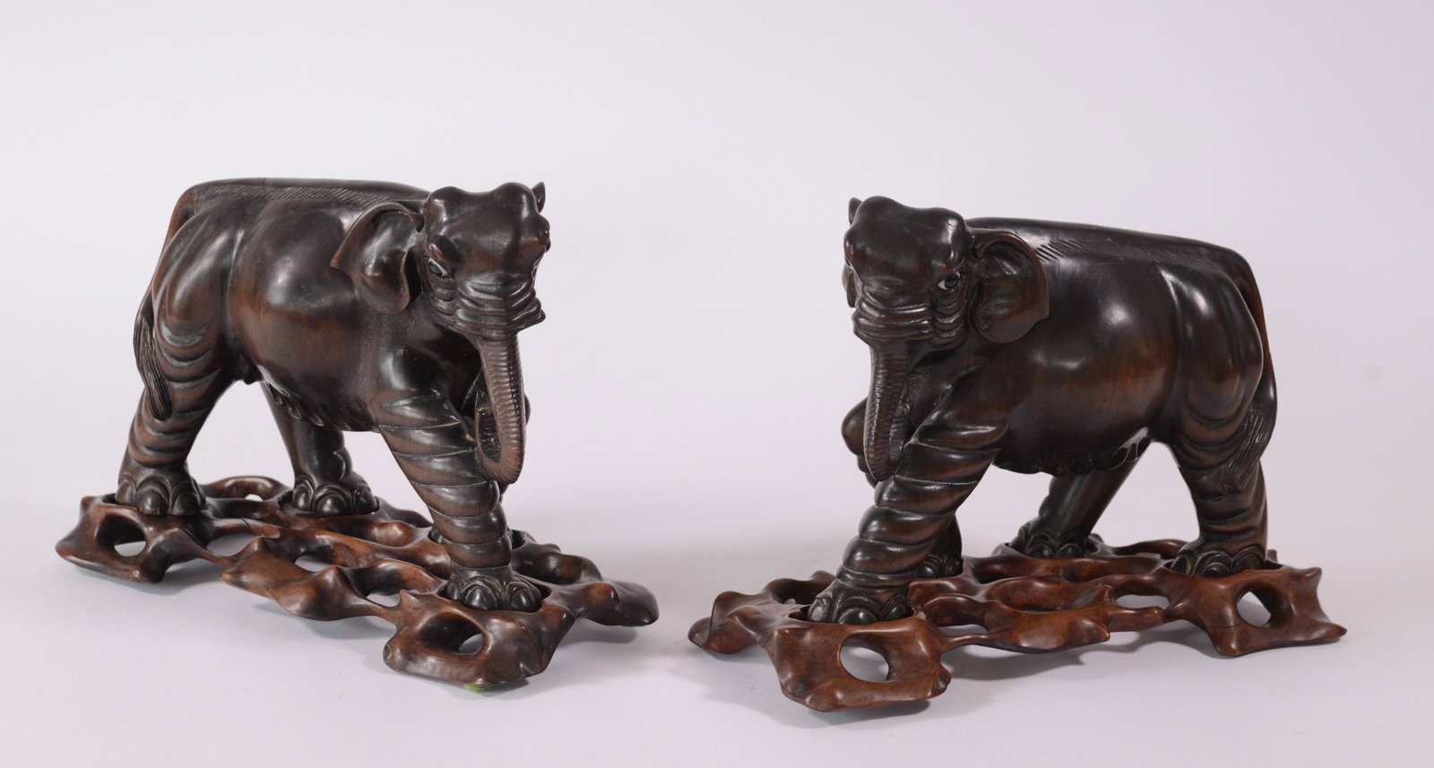 Pair of Carved Wooden Elephants.: With glass eyes, length 10 inches.