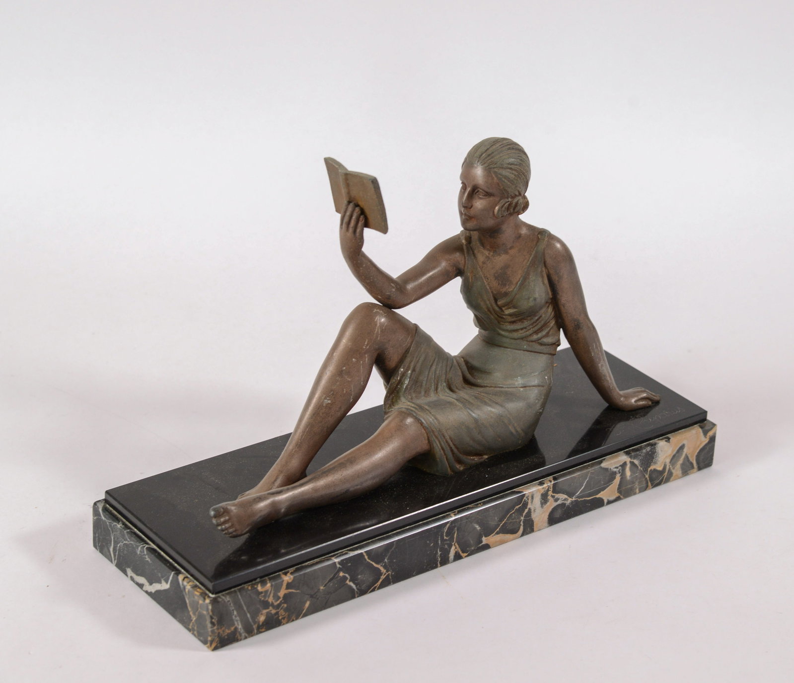 Dem?©tre Chiparus. Woman Reading a Book.: On a marble base, length 14 inches. Signed.