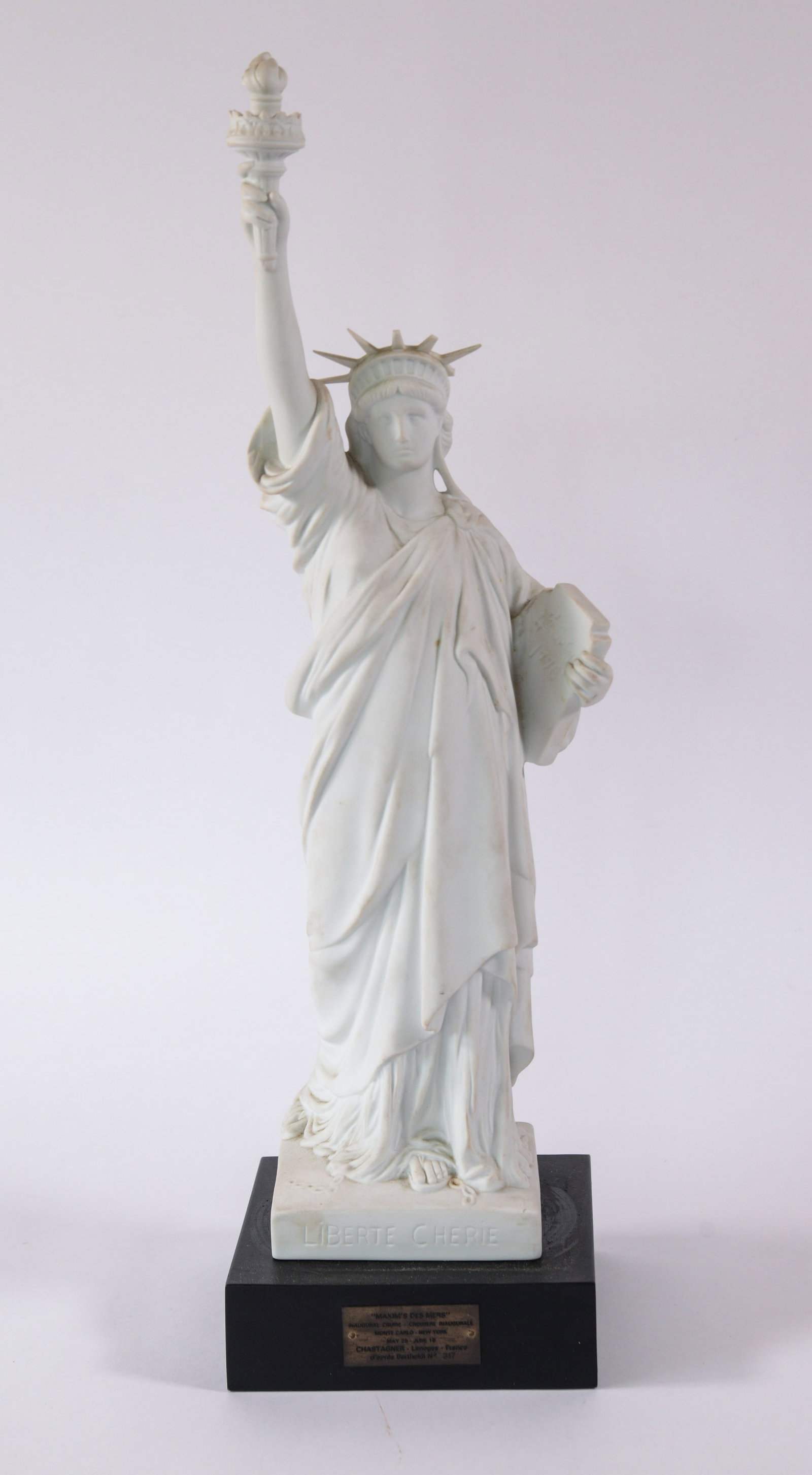 JERRY WEINTRAUB LIMOGES / CARDIN STATUE OF LIBERTY: Height 21 inches. Brass inscription plate that reads "'Maxim's des Mers'/ Inaugural Cruise - Croisiere Inaugurale/ Monte Carlo - New York/ May 25 - June 18/ Chastagner - Limoges - France/ d'apr?¨s