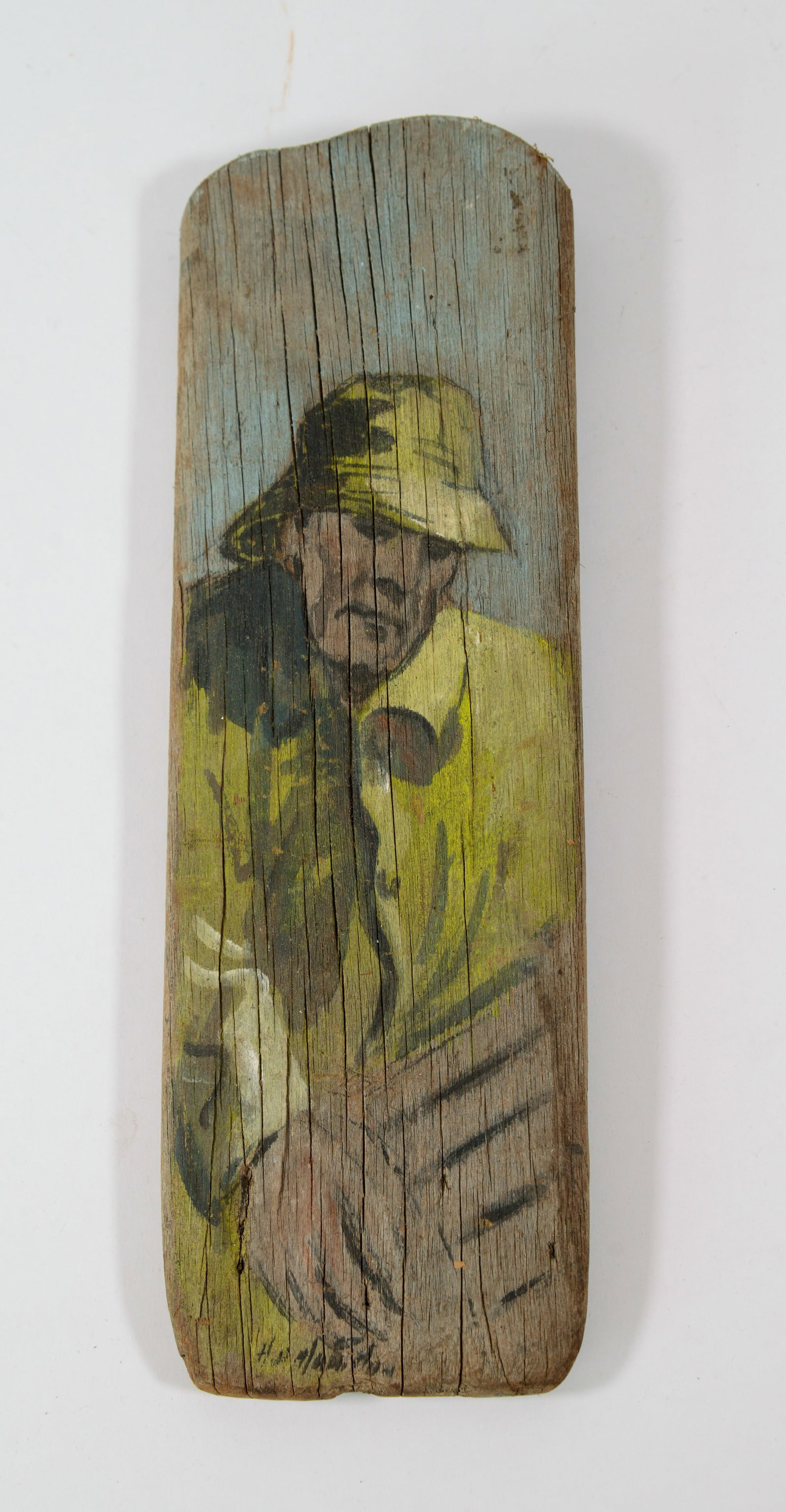 Painting on Driftwood of a Fisherman.: 13 x 4 inches.