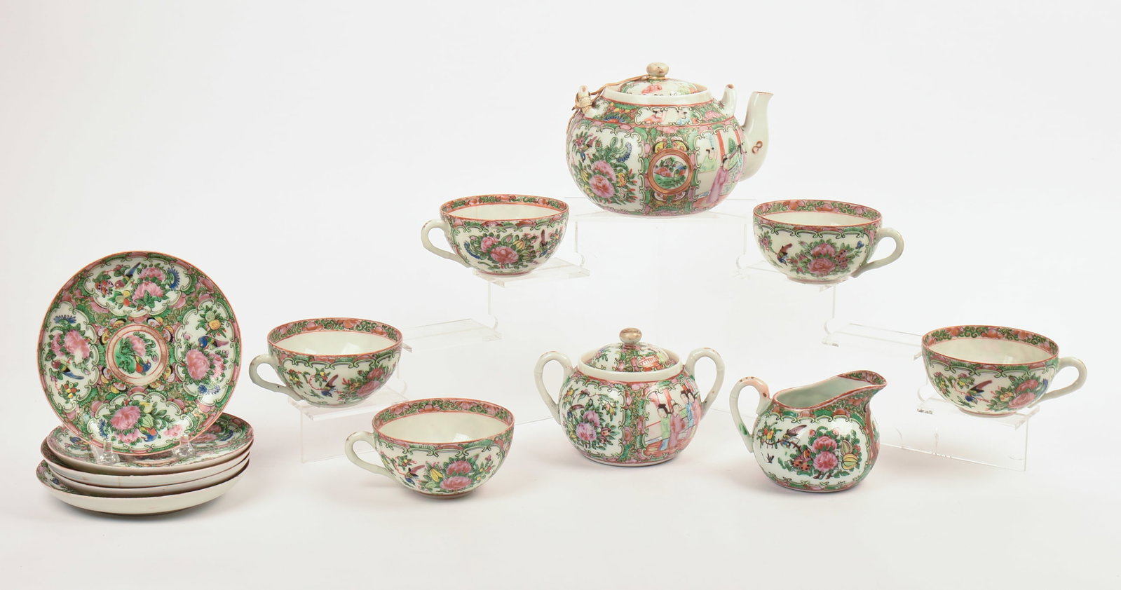 Chinese Rose Medallion Tea Service: Includes teapot, height 4.5 inches, five cups and saucers, creamer and sugar. Repaired break to teapot handle, some small chips to cups and saucers.