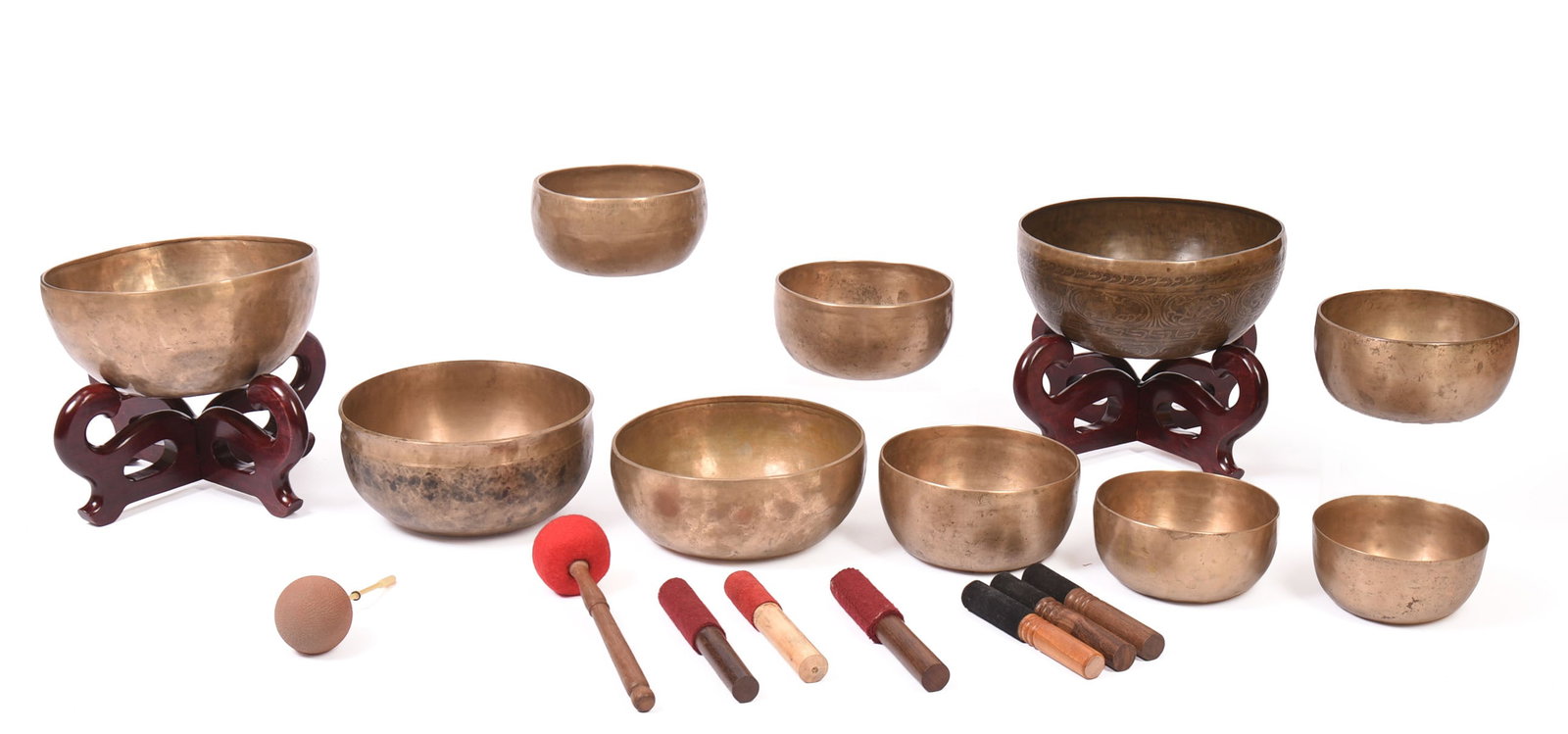 Ten Brass Singing Bowls.: Diameters 6 to 11 inches. With two wooden stands for largest bowls and 8 mallets.