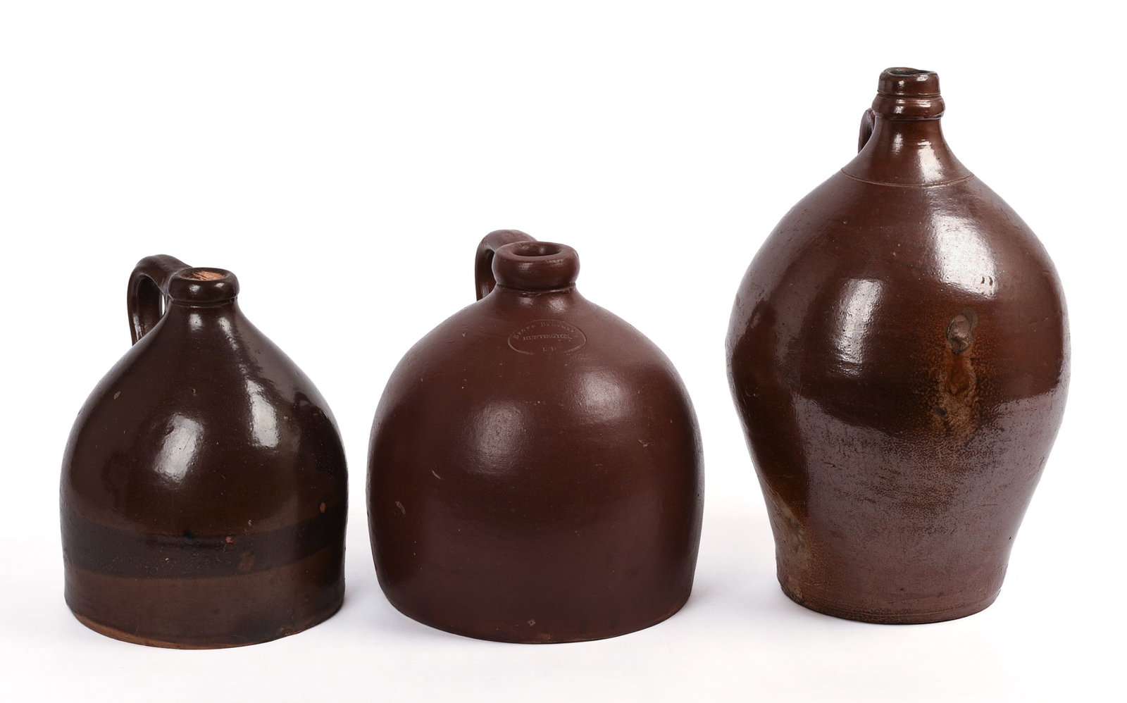 Three Redware Jugs.: Heights 8, 9 and 13 inches. Some small chips.