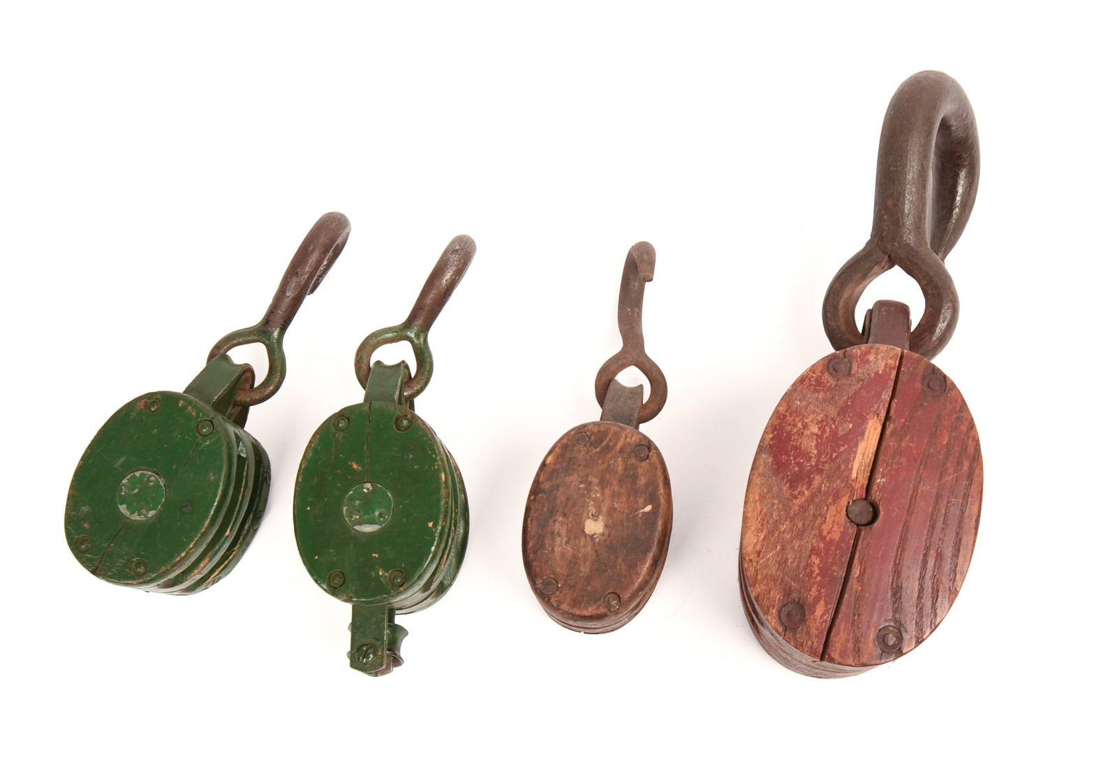 Four Antique Pulleys.: Two in green paint. Height of largest 14 inches including hook.