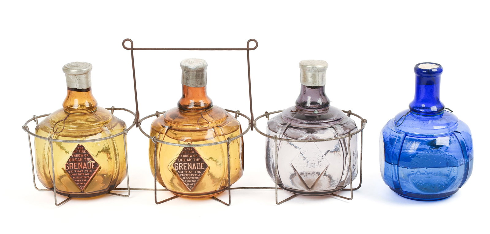 Hayward's Grenade Fire Extinguisher Bottles/Rack: Complete with original wire basket. Two grenades in amber and one in green. Each with "Hayward Hand Grenade Fire Extinguisher", "Patented Aug 8 1870", "Hayward 407 Broadcasting in the liquid.way NY"