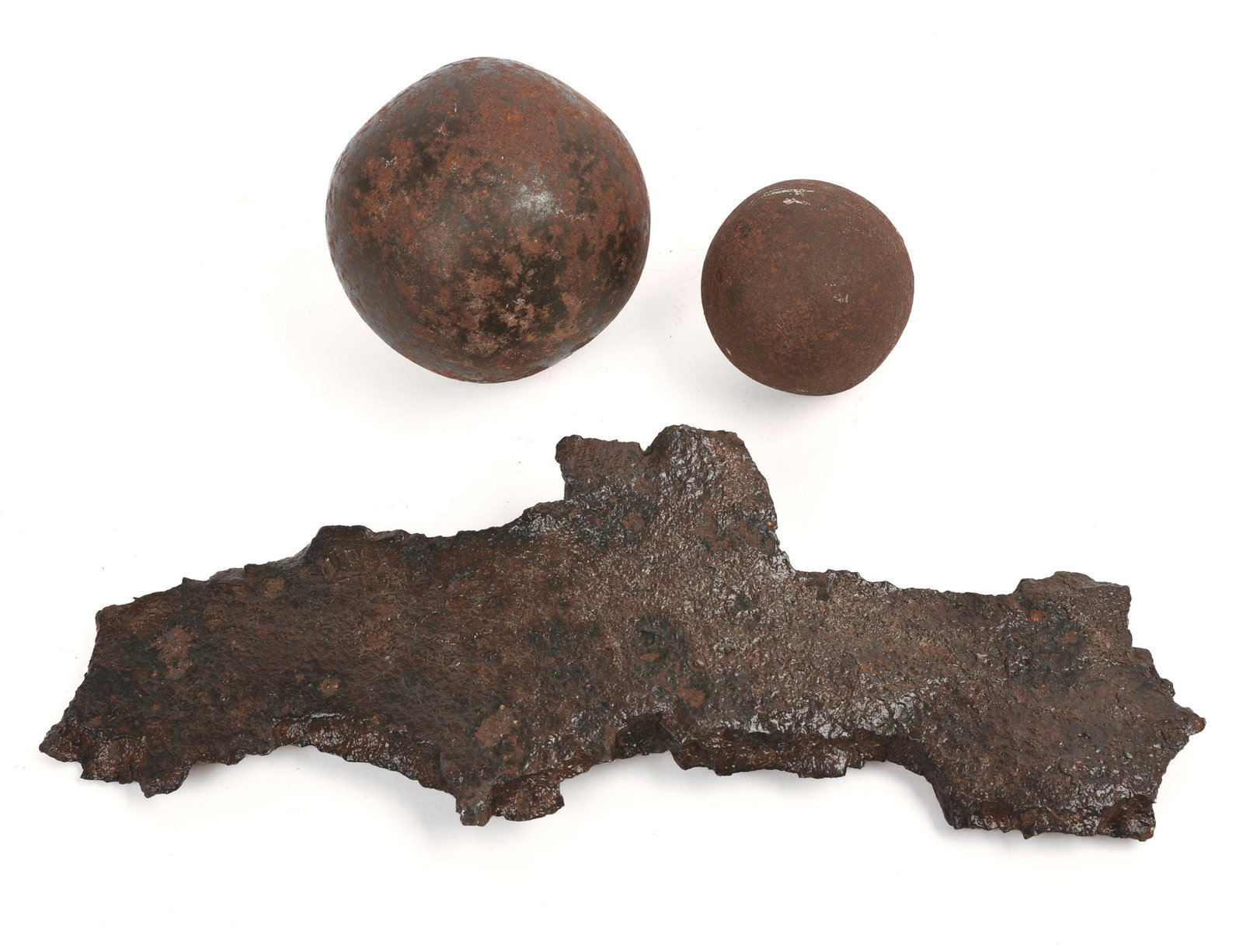 Two Cannonballs and a Piece of Shrapnel.: Diameters of cannonballs 1.75 and 2.75 inches.