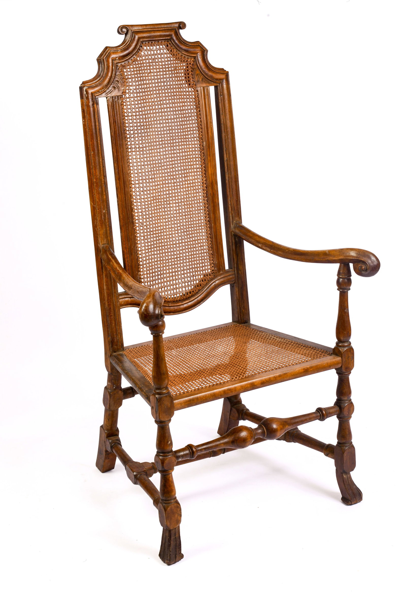 18TH CENTURY NEW ENGLAND SPANISH FOOT ARMCHAIR.: Shaped crest, carved arms, and turned stretchers. Seat height 16 inches, overall height 47.5 inches, width 26 inches, depth 21 inches. Back legs pieced out.