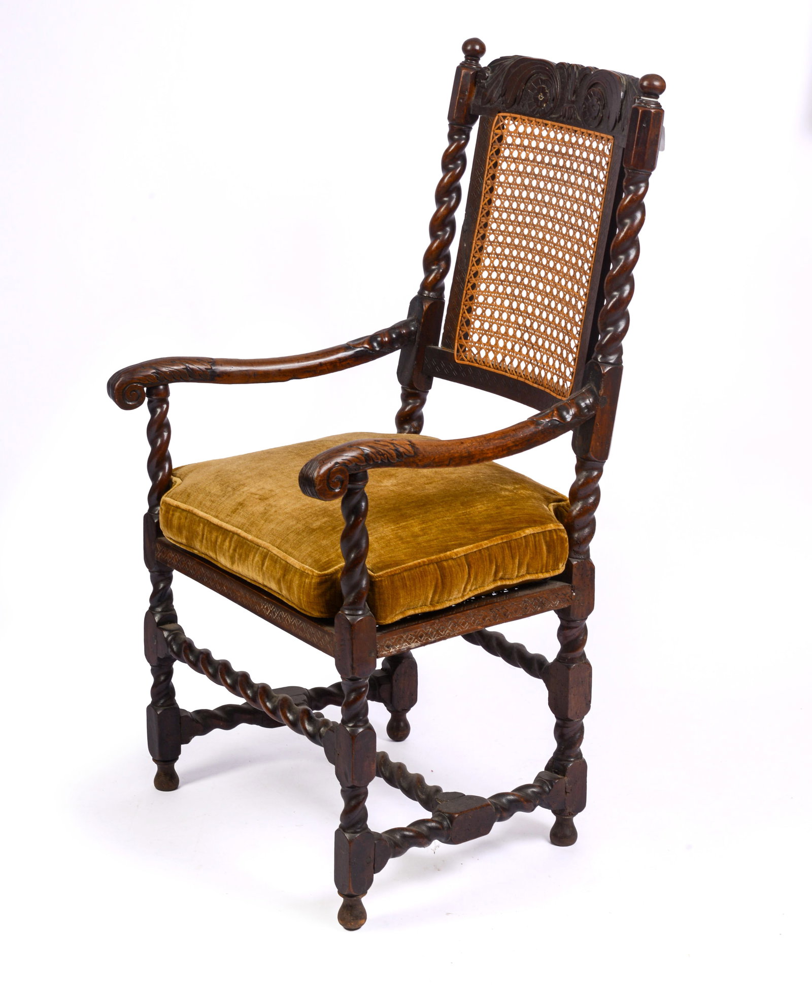 FINE 17TH-CENTURY ENGLISH CANED ARMCHAIR.: With barley-twist turnings, carved and molded arms, and turned finials. Circa 1670. Seat height 16 inches, overall height 43 inches, width 21 inches, depth 19 inches.