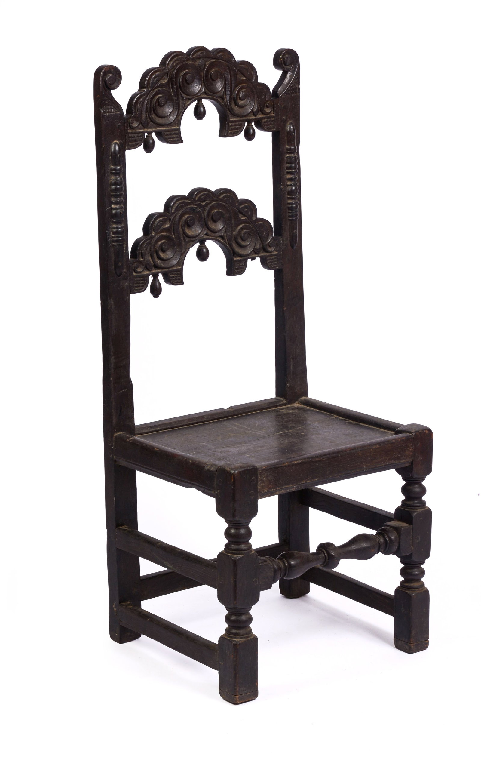 YORKSHIRE CARVED OAK BACK STOOL. CIRCA 1670 - 1690.: Shaped back crest with carved scrolls and drop pendants. By repute, the carved center of the back rail covertly represents the head of Charles I, and the acorn from the oak tree in which he hid after 