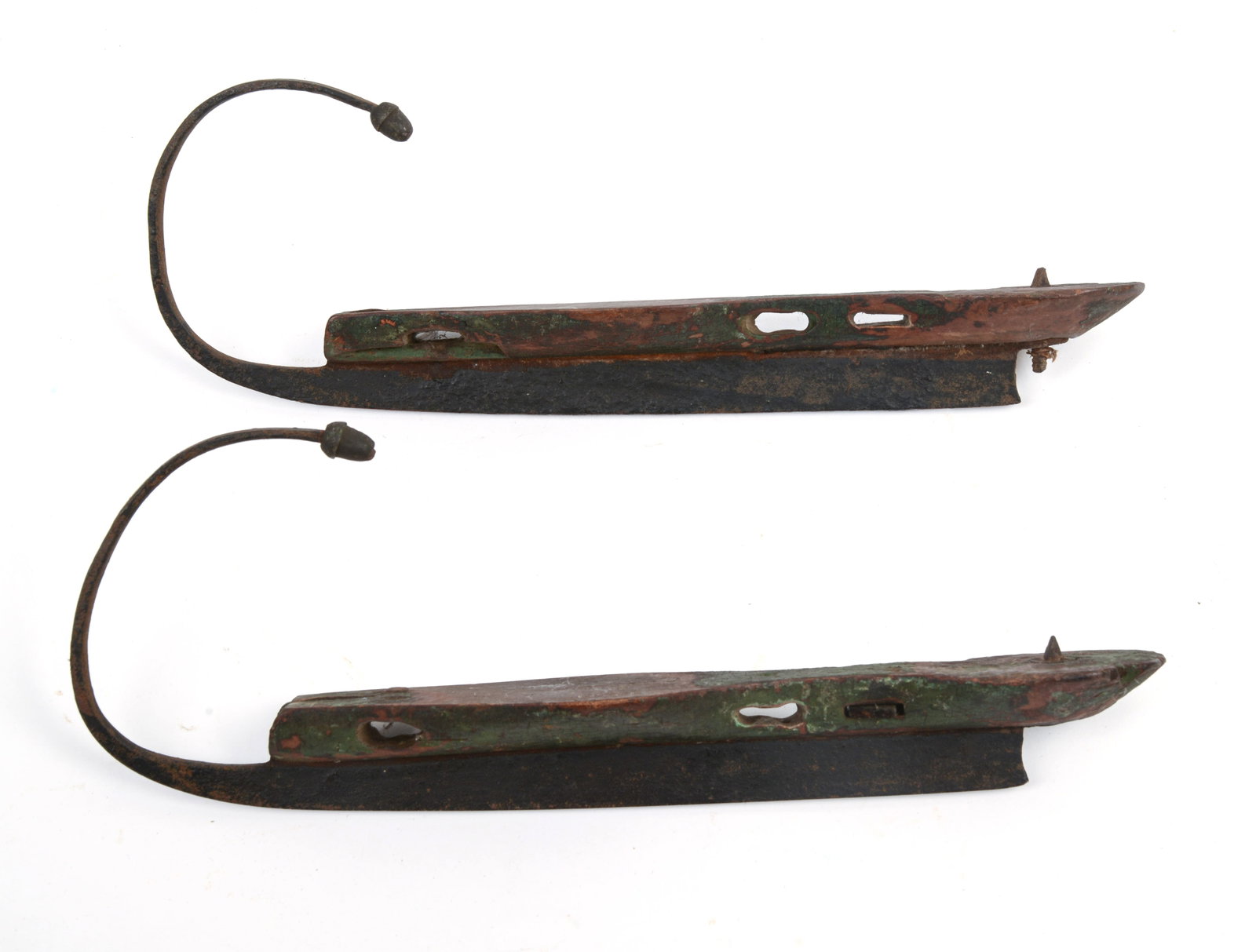 19TH CENTURY STEEL-AND-WOOD ICE SKATES.: With acorn detail, original paint. Length 11.5 inches.