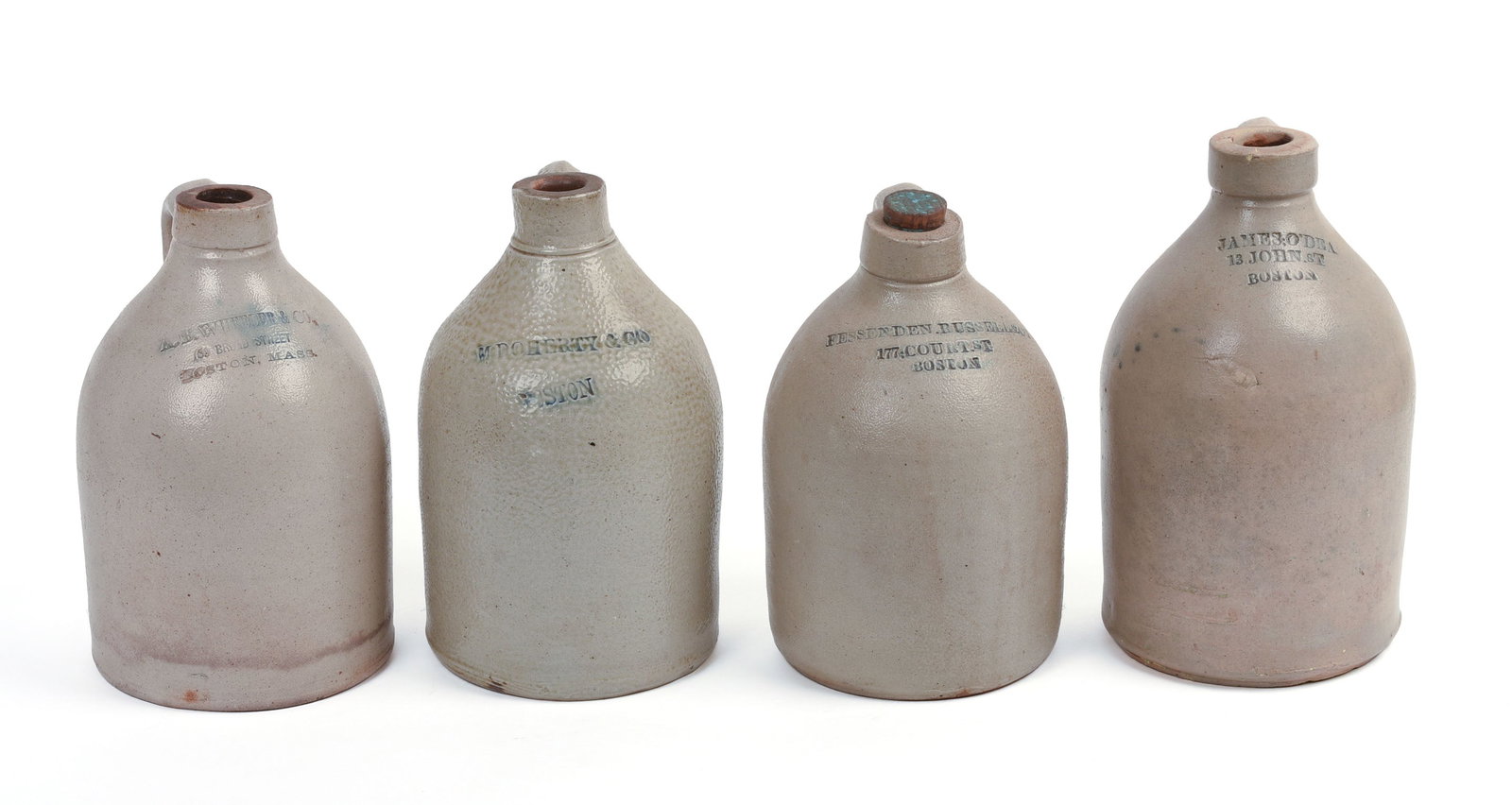 FOUR SMALL BOSTON STONEWARE JUGS.: A.S. Wheeler & Co, James O'Dea, M. Doherty & Co, and Fessenden, Russell & Co. Heights 9 to 10.5 inches.