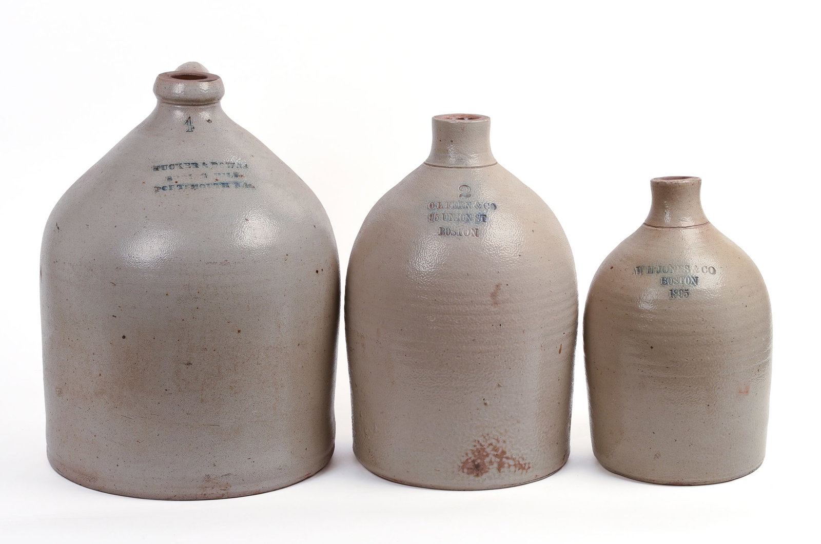 THREE STONEWARE JUGS.: WH Jones & Co, Boston, MA, 1895; height 12 inches. OL Fern & Co, Boston, MA; height 14 inches. Tucker & Downs, Portsmouth, NH, height 15.5 inches.