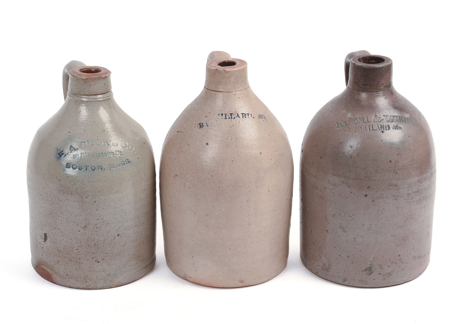THREE SMALL STONEWARE JUGS.: Kendall & Whitney, Portland. E.A. Buck & Co, Boston. One with markings rubbed. Heights 9 to 9.5 inches.