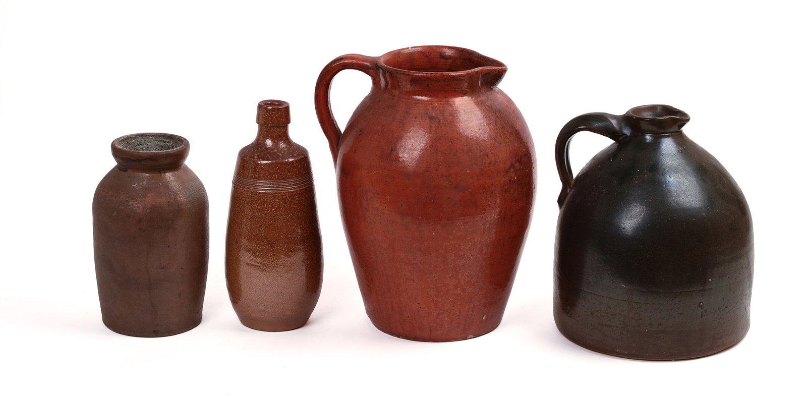 FOUR STONEWARE PIECES.: Large red pitcher, height 11.25 inches, and three others.