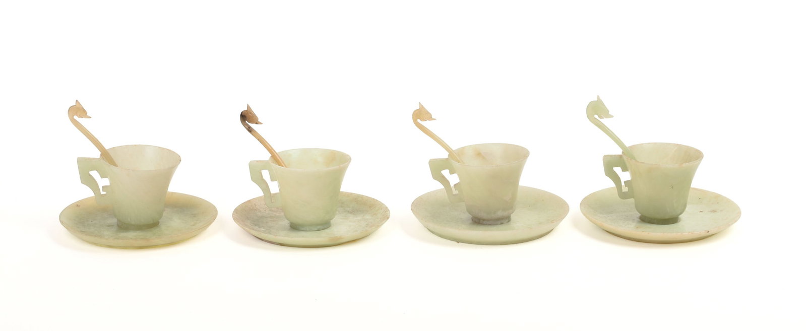 FOUR CHINESE JADE TEA CUPS, SAUCERS, AND SPOONS.: Height of teacups 2.25 inches, diameter of saucers 4.75 inches. Good condition.