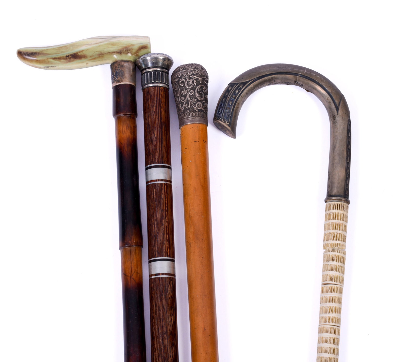 FOUR CANES.: One with shark vertebrae (length 35 inches), one with hidden vials, and two others.