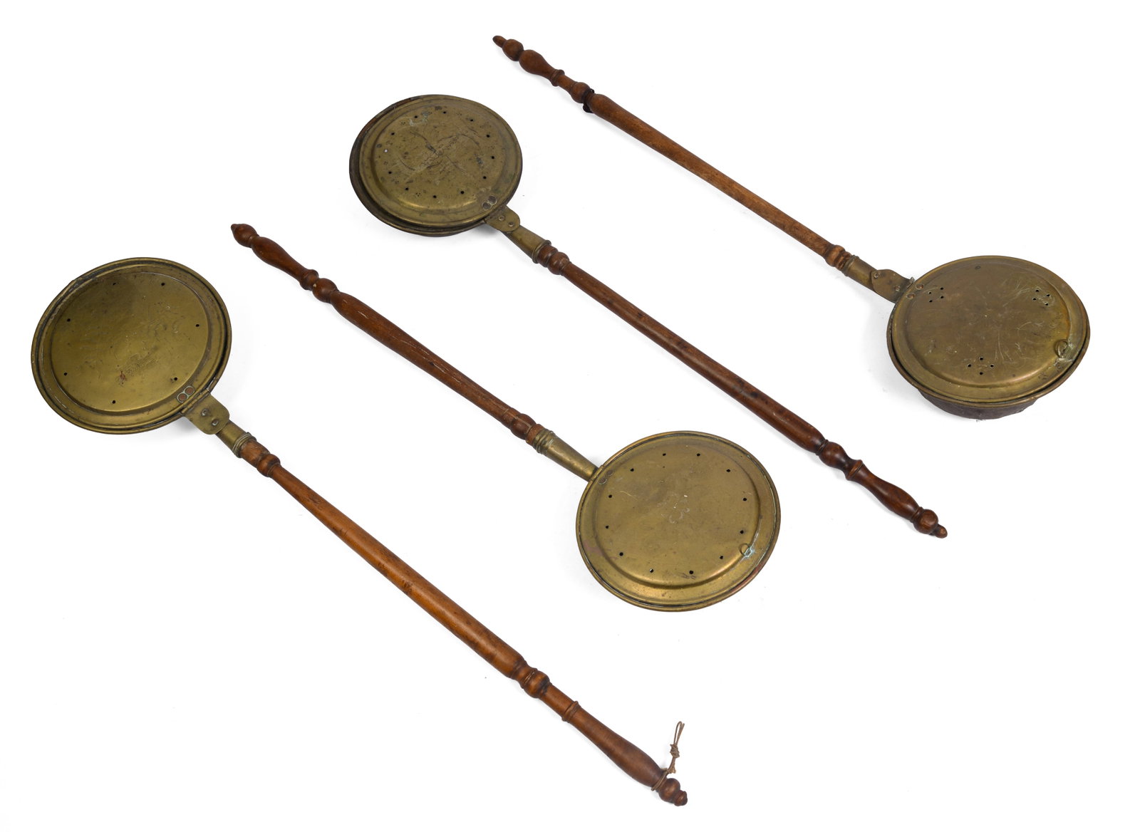 LOT OF FOUR 18TH CENTURY BRASS BED WARMERS.: Lengths 39 to 43 inches.