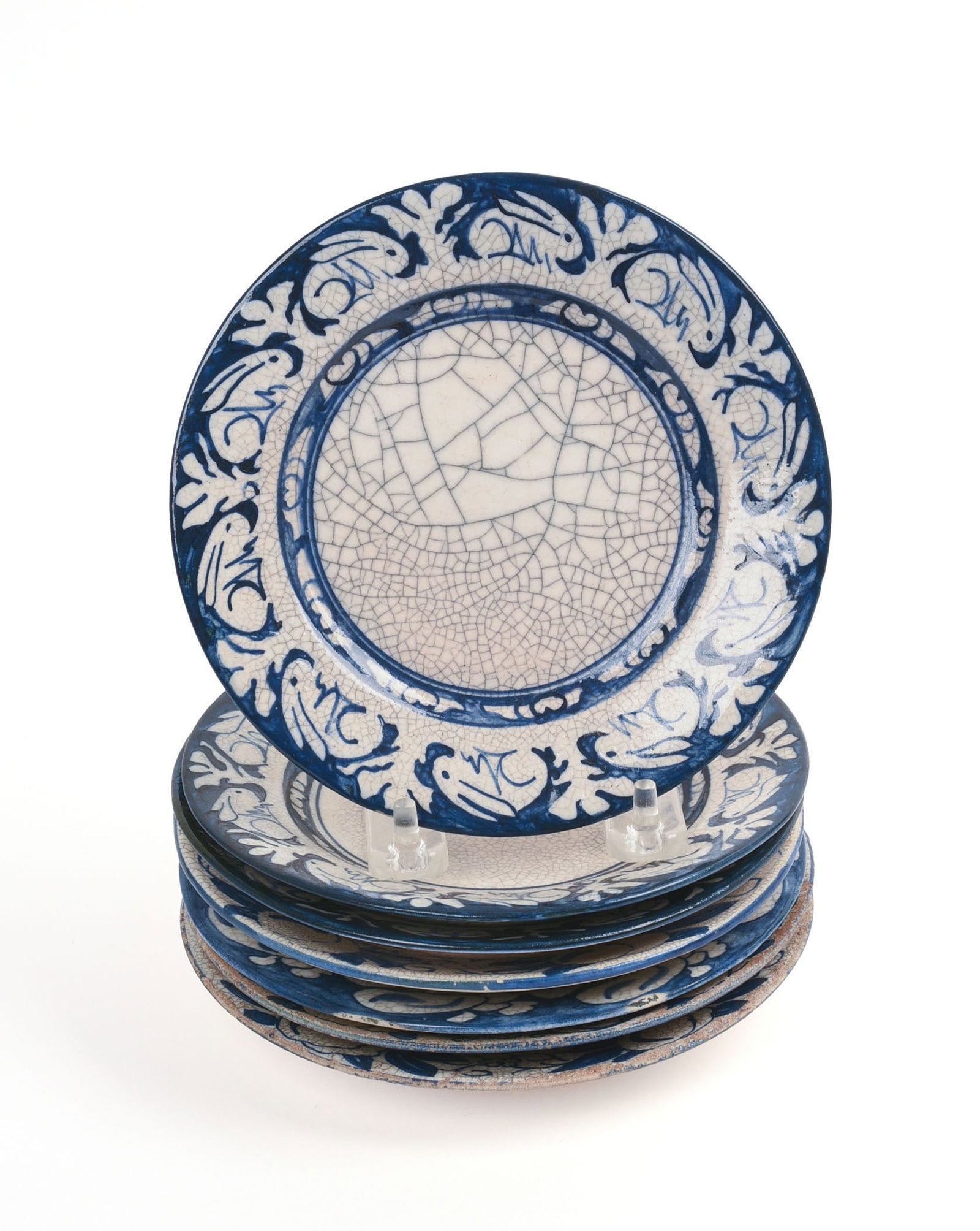 SEVEN SMALL DEDHAM POTTERY PLATES.: Three rabbit pattern and four others, diameter 6.25 inches. Some rim chips and surface loss.