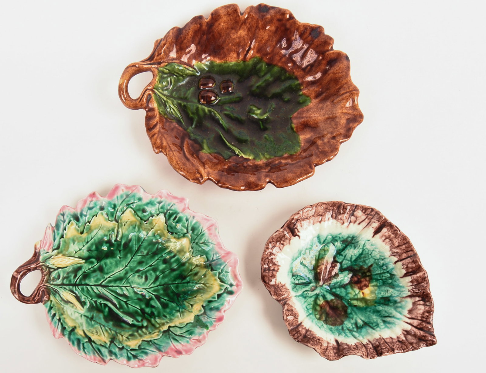 Three Majolica Leaf Dishes.: Two marked Etruscan. 9 x 7, 12 x 9 and 11.5 x 8.5 inches. Good condition.