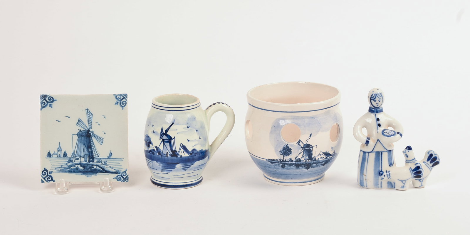 Four Dutch Delft Pieces.: Tile, 4 x 4 inches, a figure, small pitcher, and a garlic pot.