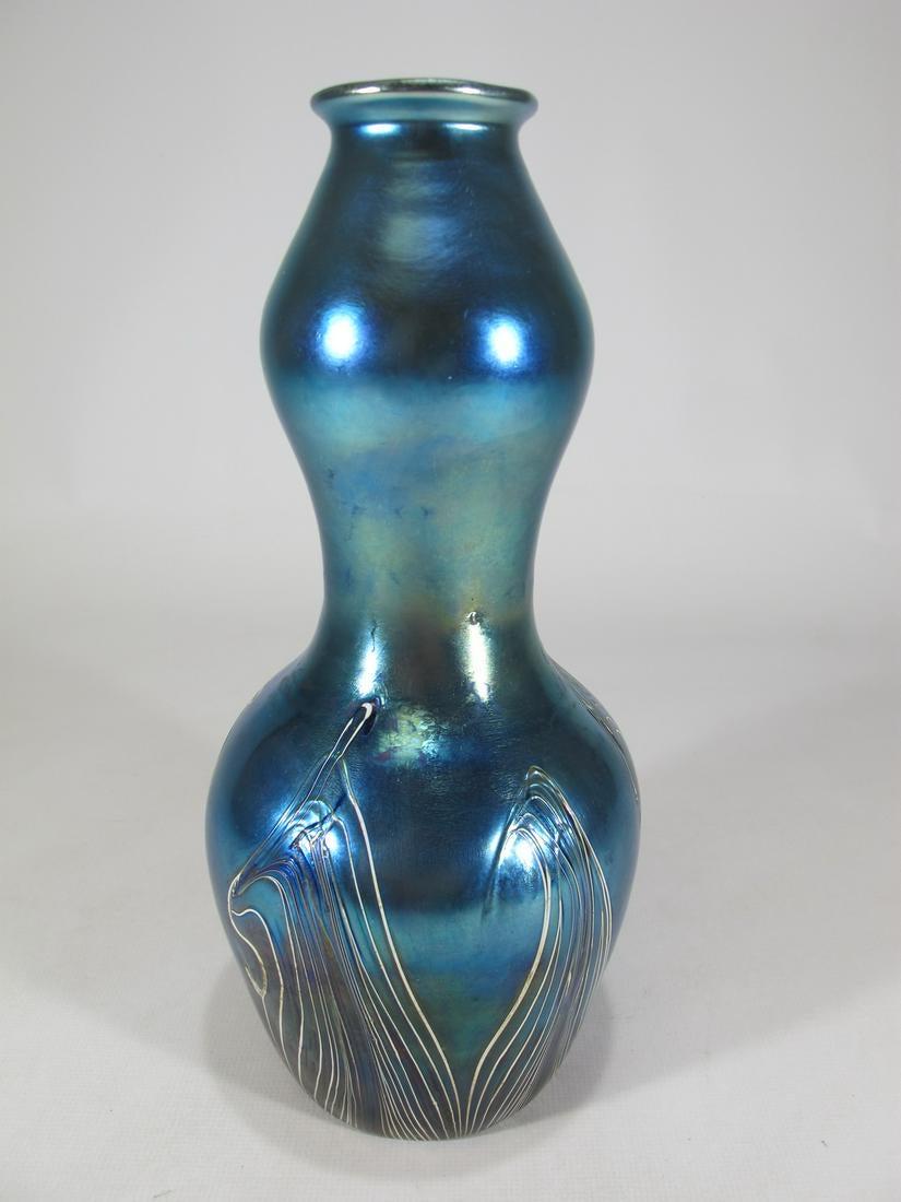 Probably Loetz blue iridescent glass vase.: Probably Loetz blue iridescent glass vase. 8 7/8” H x 3 3/4” W.