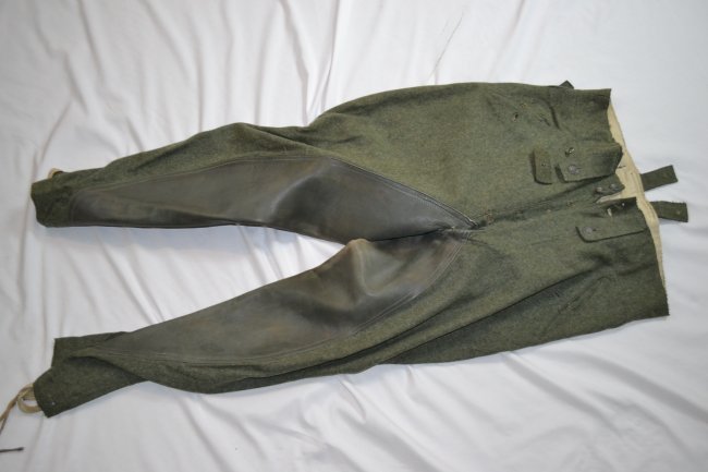 WWII GERMAN ARMY M43 CAVALRY FIELD UNIFORM TROUSERS: WWII GERMAN ARMY M43 CAVALRY STYLE FIELD UNIFORM TROUSERS . LEATHER INSERT SEW IN BETWEEN THE LEGS.RIDING TROUSERS. ROUGH TEXTURE HEAVY WOOL . ORIGINAL GERMAN ISSUE INK STAMPS AND DATED 1944 . NICE CL