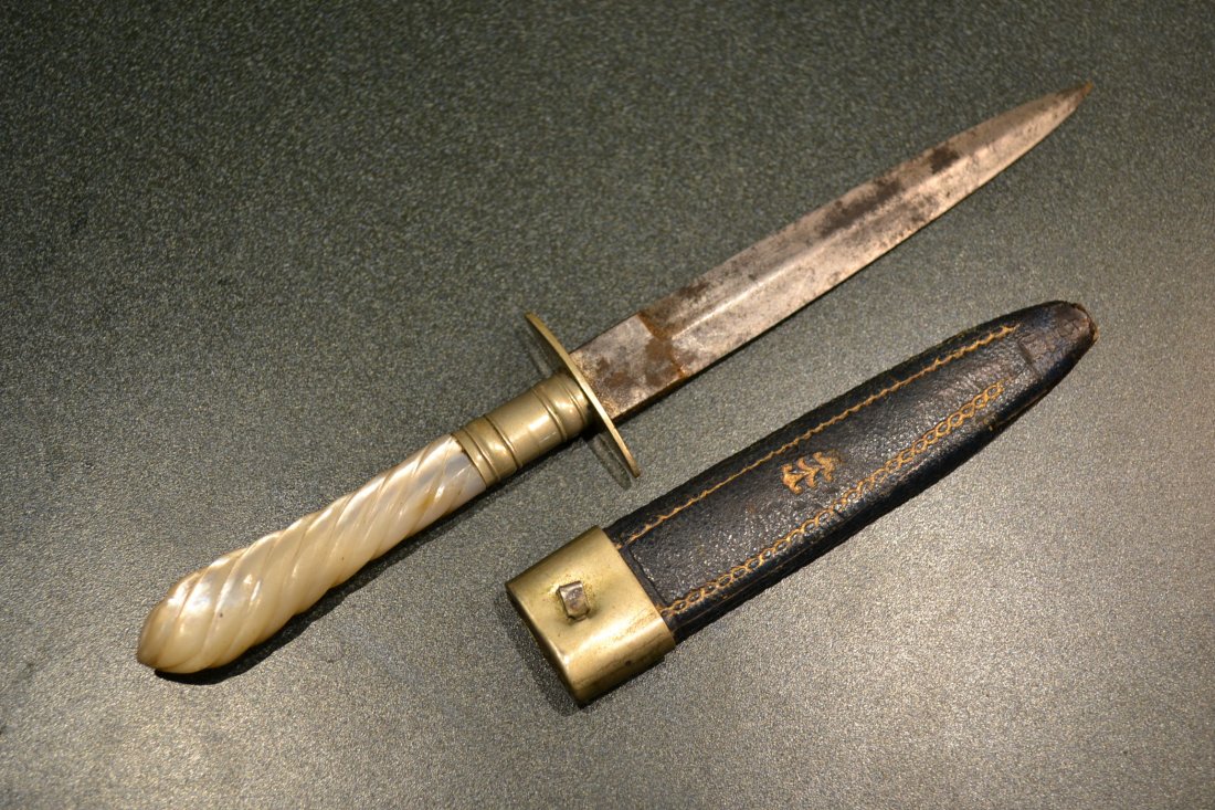 ANTIQUE VICTORIAN BRITISH DAGGER KNIFE SHEFFIELD: ANTIQUE VICTORIAN BRITISH DAGGER KNIFE SHEFFIELD , DISPLAYS A GREAT AGE. MAKER MARKED BLADE . MOTHER OF PEARL GRIP . LEATHER SHEET. 7" LONG WITH 4" BLADE .