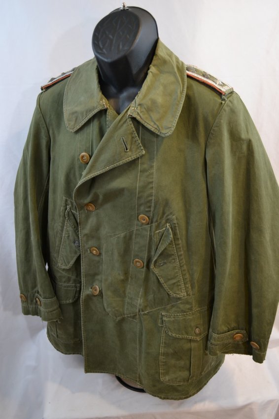WWII GERMAN JAGGER MOUNTAIN TROOPS NCO RAIN COAT JACKET: WWII GERMAN JAGGER MOUNTAIN TROOPS NCO RAIN COAT JACKET . GOOD WELL WORN CONDITION WITH NCO OFFICER'S SHOULDER BOARDS.