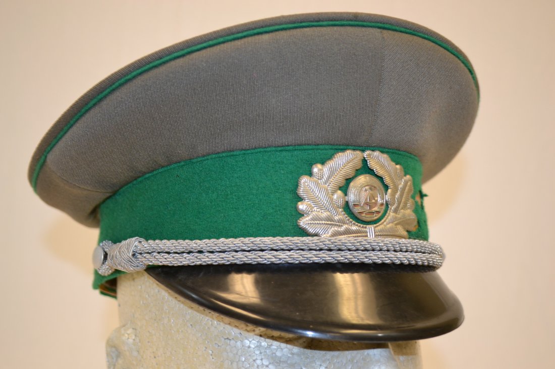 VINTAGE EAST GERMAN VISOR CAP DDR COLD WAR ERA: VINTAGE EAST GERMAN ARMY VISOR CAP DDR. COLD WAR ERA. SIZE 56 . MUCH WEAR AND MOTH DAMAGE .