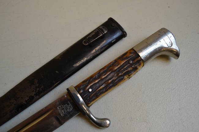 WWII GERMAN SHORT DRESS BAYONET EICKHORN STAG GRIP: WWII GERMAN SHORT DRESS BAYONET. EICKHORN MADE . STAG GRIPS. SHOWS WEAR AND AGE SOME GRINDING TO THE BLADE AND FINISH WEAR TO SCABBARD BUT ALL ORIGINAL UNCLEANED AND UNTOUCHED CONDITION