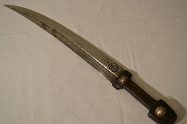 ANTIQUE RUSSIAN COSSACK CAUCASIAN BEBUT DAGGER: ANTIQUE RUSSIAN COSSACK CAUCASIAN BEBUT DAGGER . VERY BEAUTIFUL PIECE. NICE MAKERS STAMPS ON BOTH SIDE WITH ARABIC SYMBOLS. SILVER DECORATED FITTINGS ON THE GRIP . NO SCABBARD.18" LONG WITH 13.5" BLAD